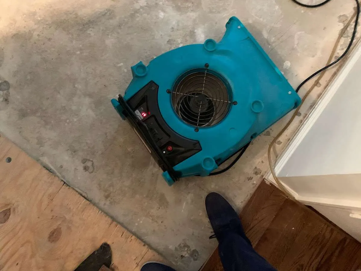 Air mover drying subfloor during Commercial Water Damage Restoration in El Dorado
